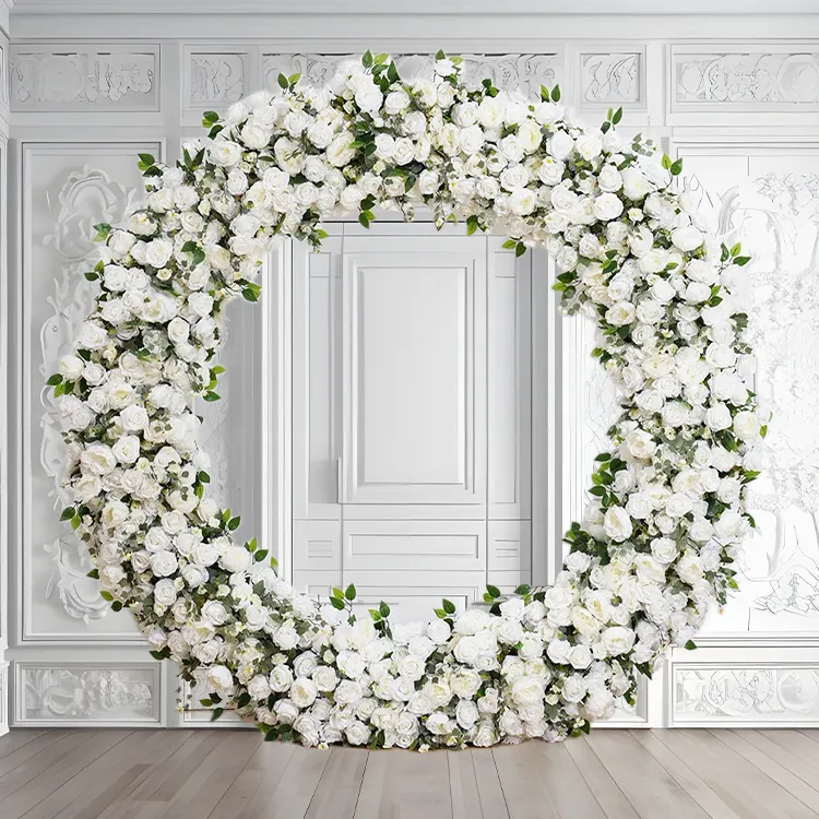 C — A green and white archway with an open, sculptural sweep and foliage worked through in generous drifts