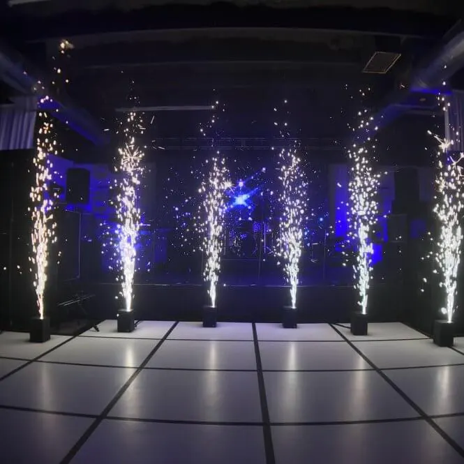 Cold Spark Fountains — Cold spark fountains on cue as she says yes — all the drama of pyrotechnics, safe indoors