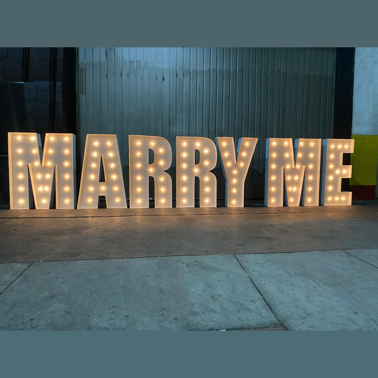 Marry Me Marquee Letters — Illuminated MARRY ME letters, tall enough to read across a rooftop and bright enough to shoot at night
