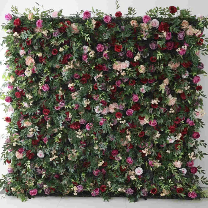 Monarch — An English-garden wall: dense green foliage with roses scattered through it in magenta, blush, cream and deep red