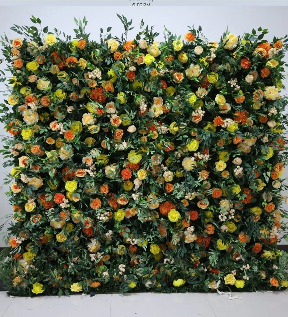 Sunset — This vibrant flower wall features a stunning array of orange and yellow roses, creating a warm and inviting atmosphere for any event